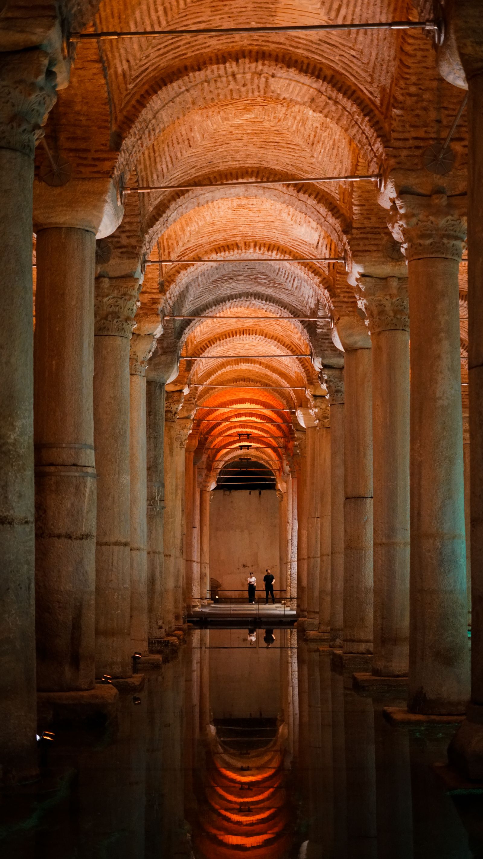 Lit arches and columns inside an Istanbul cistern